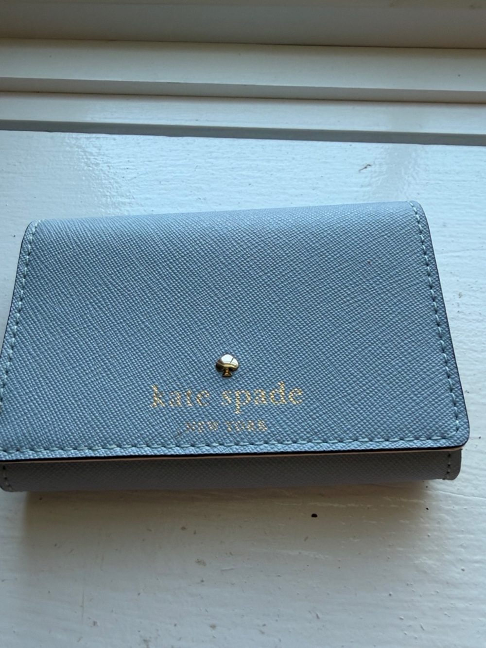kate spade light blue compact trifold wallet with gold logo